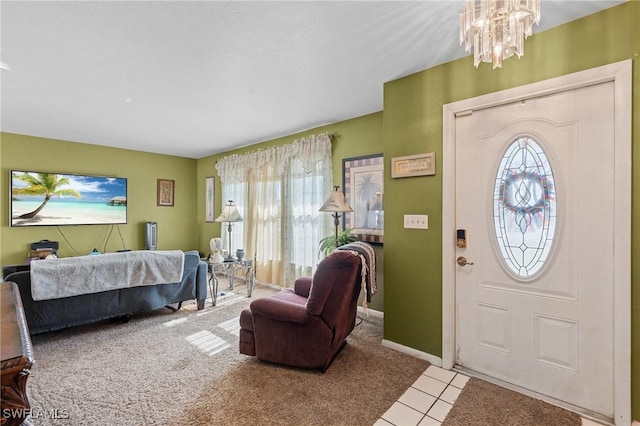 tiled entrance foyer featuring a notable chandelier and baseboards