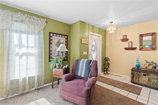 sitting room featuring tile patterned floors, baseboards, and a chandelier