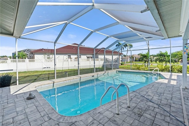 view of pool featuring a patio area, a fenced in pool, a lanai, and fence