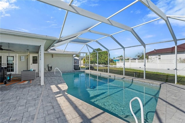 view of pool featuring fence, french doors, glass enclosure, a fenced in pool, and a patio area