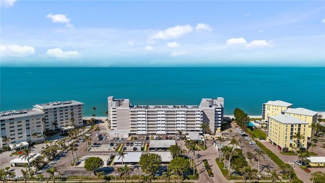 birds eye view of property featuring a water view and a city view