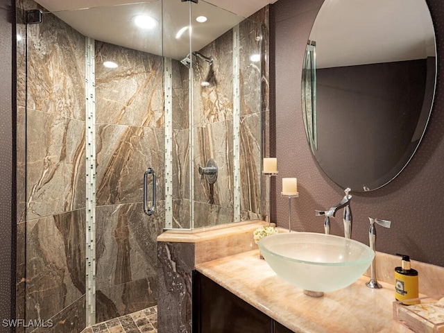 bathroom featuring recessed lighting, a shower stall, and vanity