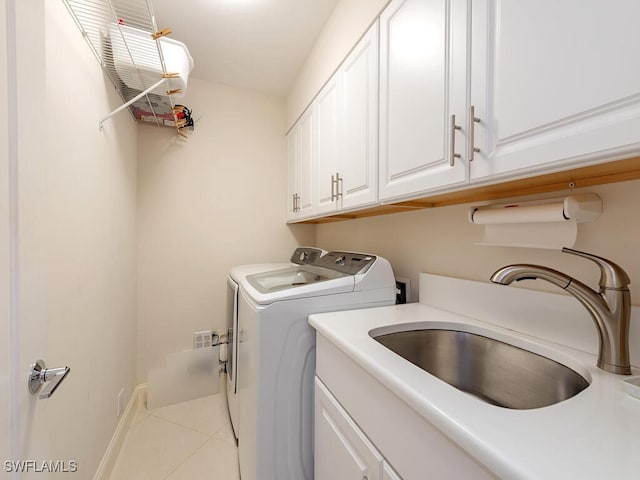 laundry area with cabinet space, independent washer and dryer, tile patterned flooring, and a sink