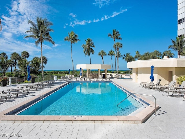 pool featuring fence and a patio area