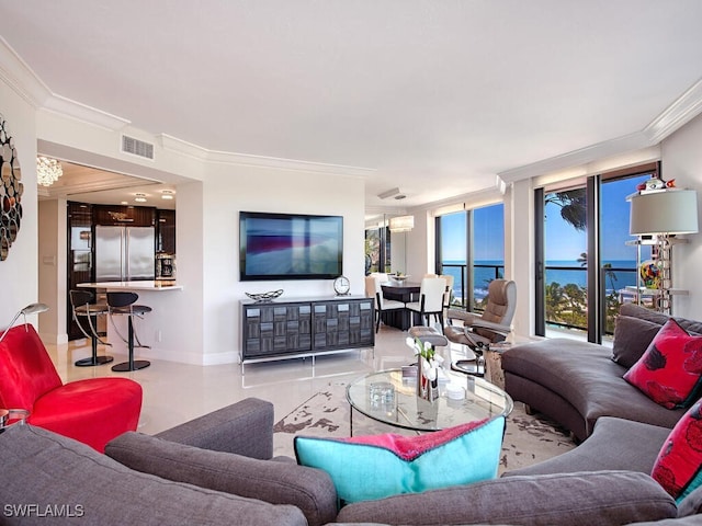 living area featuring visible vents, baseboards, and ornamental molding