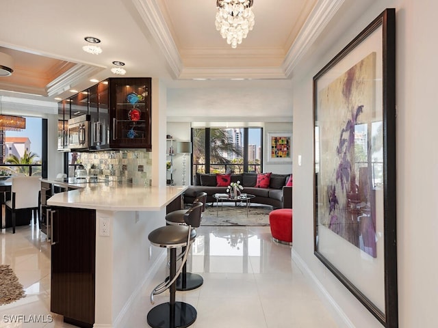 bar with crown molding, backsplash, light tile patterned flooring, and a tray ceiling