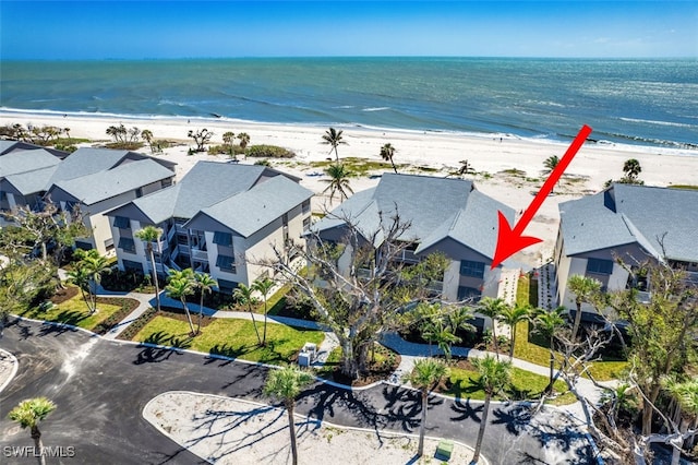 aerial view featuring a residential view, a view of the beach, and a water view