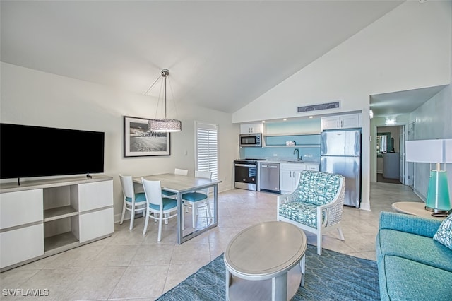 living room with light tile patterned flooring, high vaulted ceiling, and baseboards