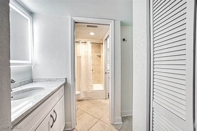 full bathroom with toilet, a textured wall, tile patterned floors, vanity, and shower / bathtub combination with curtain