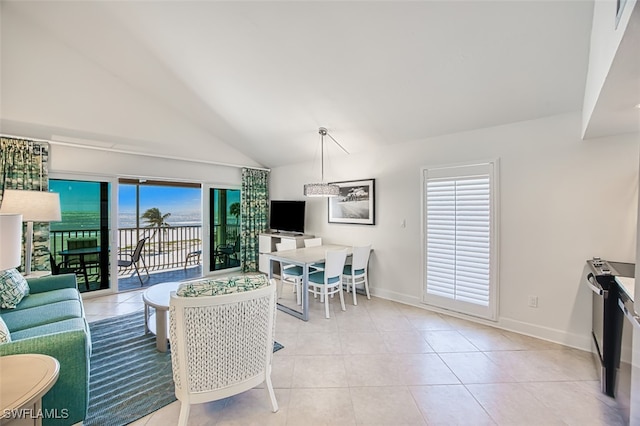 living room with light tile patterned floors, baseboards, and high vaulted ceiling