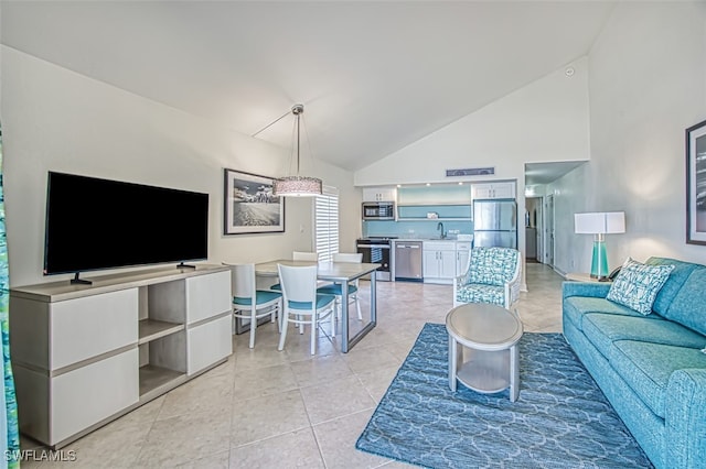 living room featuring high vaulted ceiling and light tile patterned flooring