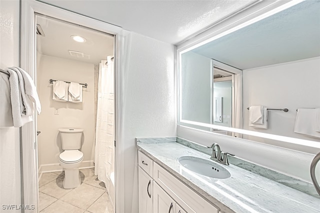 full bath with visible vents, baseboards, toilet, tile patterned floors, and vanity