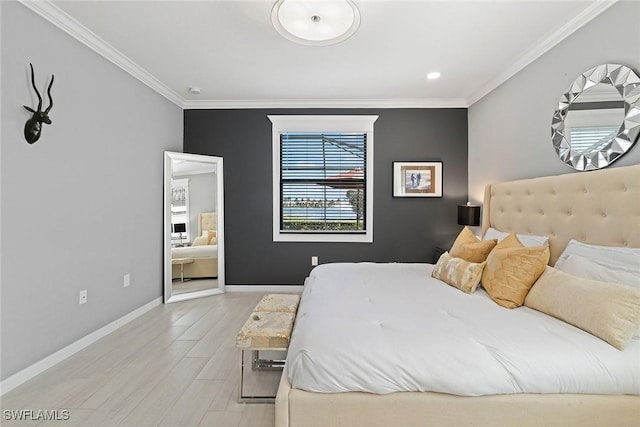 bedroom with crown molding, light wood-style flooring, and baseboards