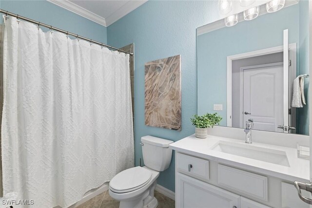 bathroom with tile patterned floors, vanity, toilet, and crown molding