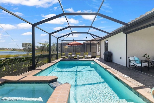 view of pool featuring glass enclosure, a patio area, a pool with connected hot tub, and a grill