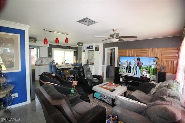 living area featuring visible vents, speckled floor, and ceiling fan