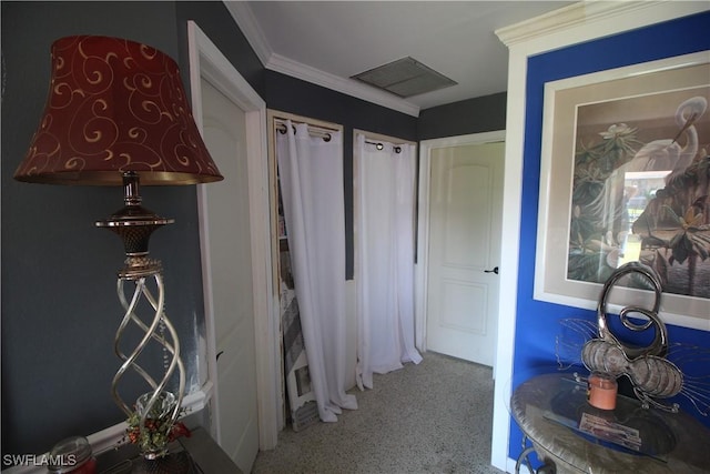 corridor with visible vents, speckled floor, and ornamental molding