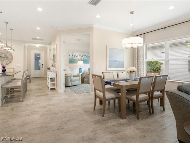 dining area with recessed lighting, baseboards, and crown molding