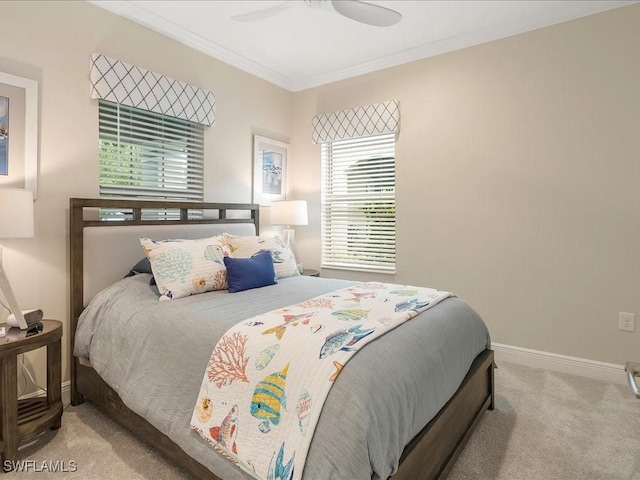 bedroom with carpet flooring, ceiling fan, baseboards, and ornamental molding