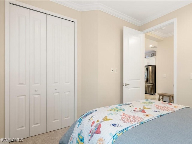 bedroom featuring a closet, light carpet, crown molding, and freestanding refrigerator