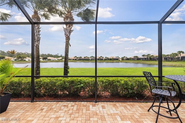 unfurnished sunroom featuring a water view