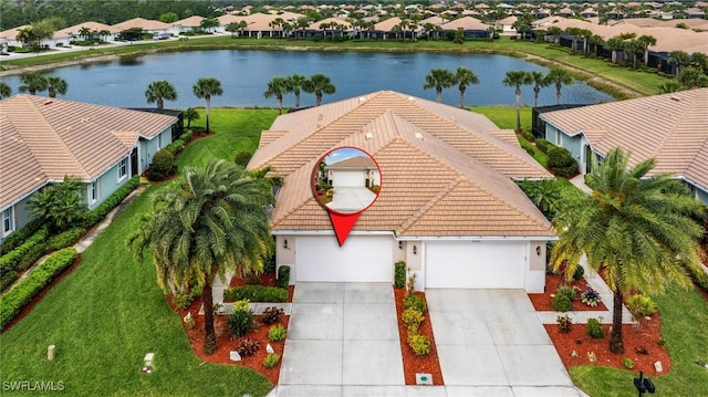 drone / aerial view with a residential view and a water view