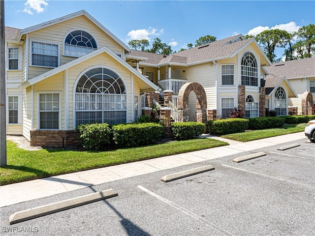 traditional-style house with brick siding and uncovered parking