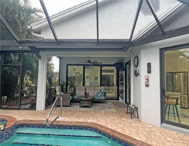 pool featuring a patio area, an outdoor hangout area, a lanai, and a ceiling fan