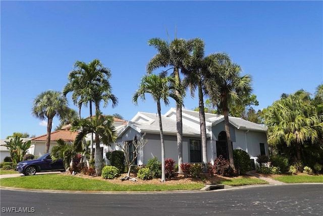 view of front facade featuring an attached garage, driveway, and stucco siding