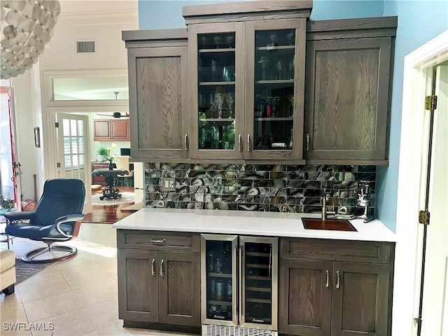 bar featuring visible vents, ornamental molding, wine cooler, decorative backsplash, and wet bar