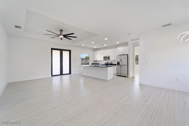 5306 Lee St, Lehigh Acres, FL 33971 - unfurnished living room with visible vents, french doors, a raised ceiling, and baseboards