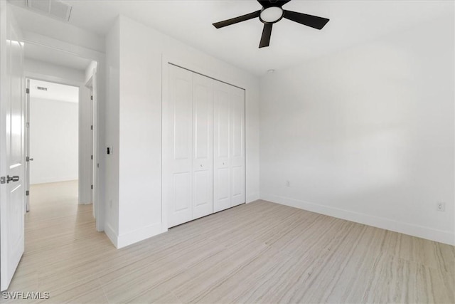 5306 Lee St, Lehigh Acres, FL 33971 - unfurnished bedroom featuring a closet, baseboards, and light wood finished floors