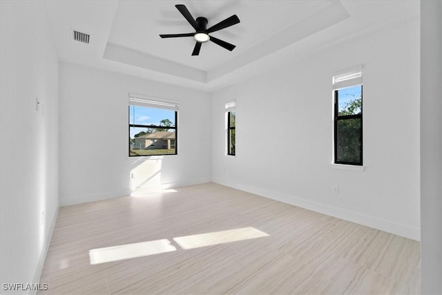5306 Lee St, Lehigh Acres, FL 33971 - empty room featuring visible vents, a raised ceiling, baseboards, and a ceiling fan