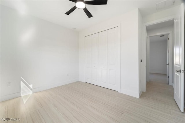 5306 Lee St, Lehigh Acres, FL 33971 - unfurnished bedroom with a ceiling fan, light wood-style floors, a closet, and baseboards
