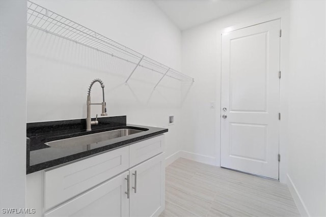 5306 Lee St, Lehigh Acres, FL 33971 - laundry room with cabinet space, hookup for a washing machine, baseboards, and a sink