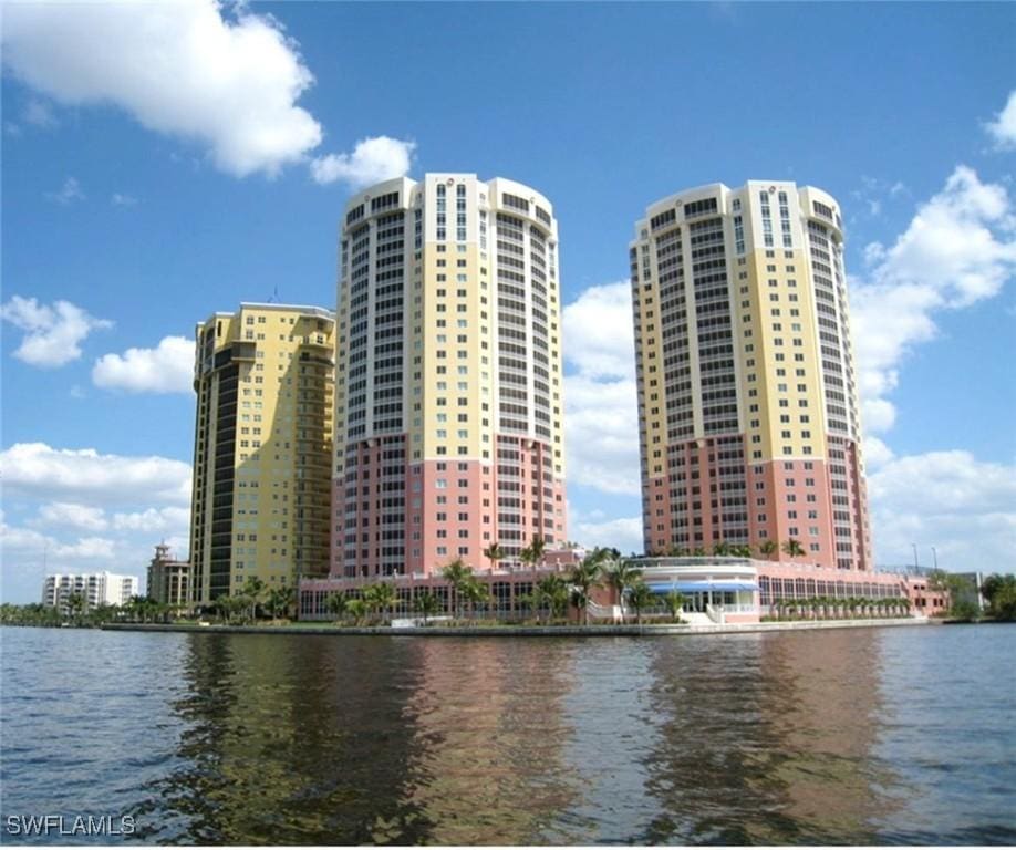 view of property with a water view and a view of city