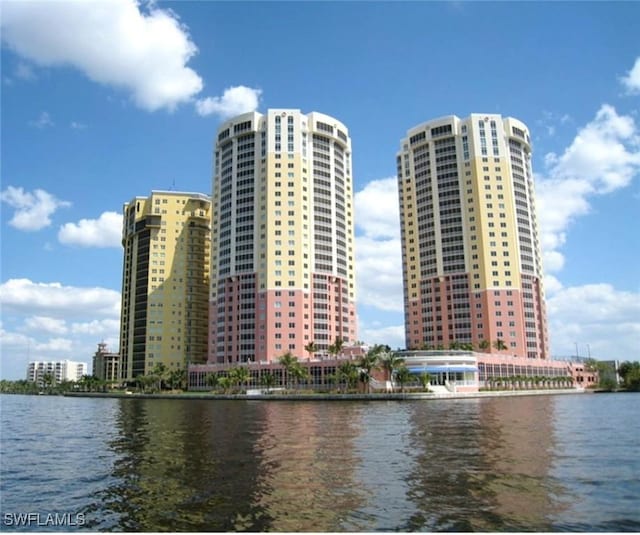 view of property with a water view and a view of city