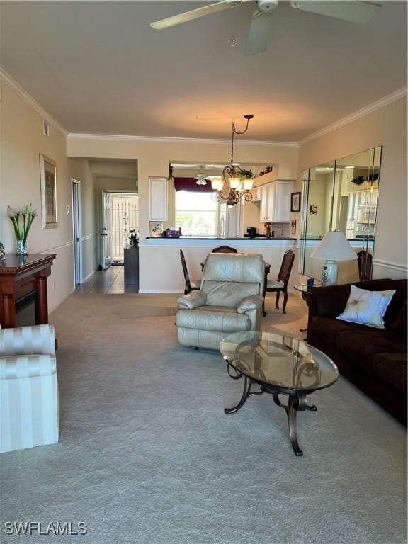 carpeted living area featuring ceiling fan with notable chandelier and ornamental molding