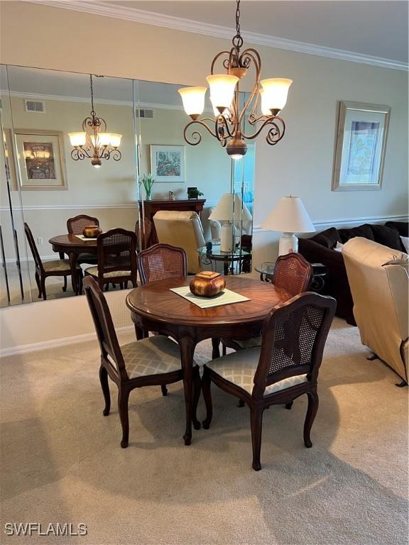 dining space with visible vents, light colored carpet, and a chandelier