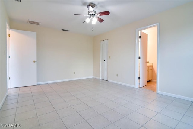 empty room featuring visible vents, baseboards, and a ceiling fan