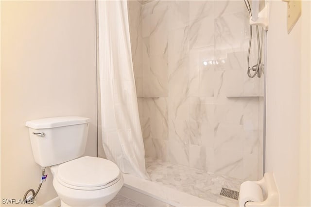 full bath featuring a shower stall and toilet