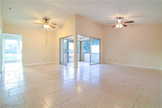 unfurnished room with light tile patterned floors, baseboards, lofted ceiling, and ceiling fan