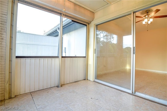 unfurnished sunroom featuring plenty of natural light and ceiling fan