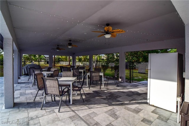 view of patio / terrace featuring outdoor dining space, ceiling fan, fence, and a grill