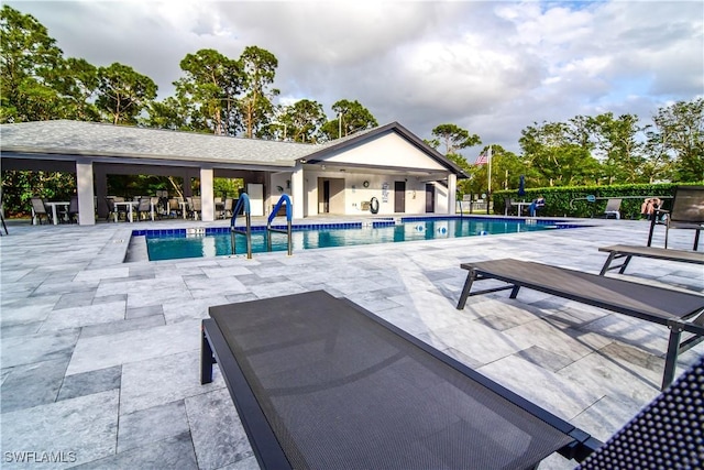 community pool featuring a patio area and fence