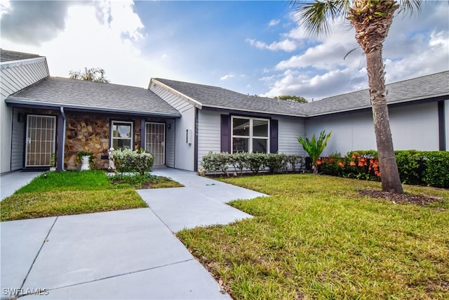 ranch-style home with a front lawn