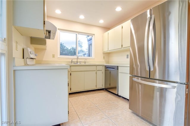 kitchen featuring a sink, recessed lighting, appliances with stainless steel finishes, light countertops, and light tile patterned floors