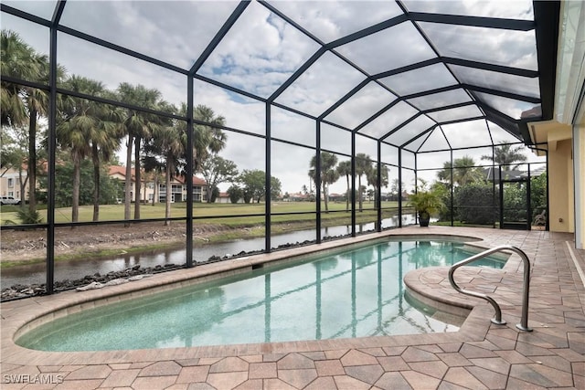 pool with a patio, a water view, and a lanai