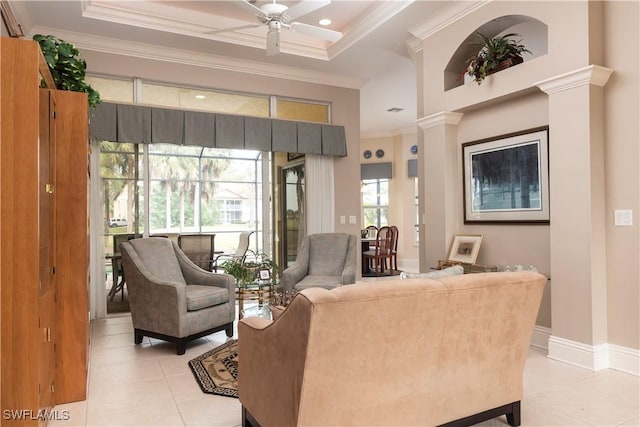 living area with crown molding, light tile patterned flooring, baseboards, and ceiling fan