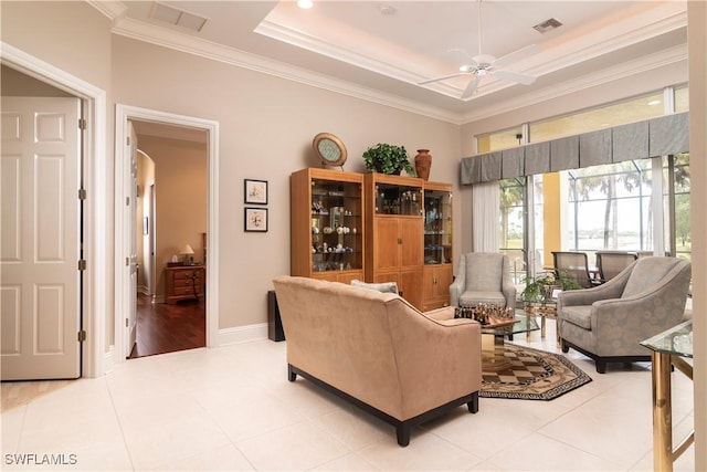 living room featuring crown molding, light tile patterned floors, visible vents, and a raised ceiling